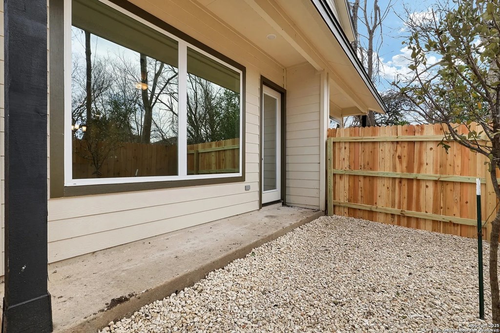 A house with a gravel area in front of it.