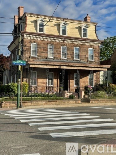 A two-story house with a front porch and a sign that says "available".