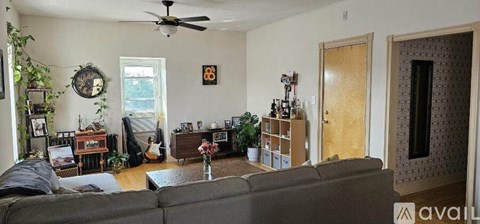 A bedroom with a bed, dresser, and window.