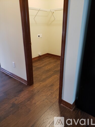 A room with wooden floors and white walls.