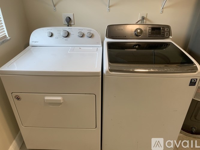 A white dryer and washer sitting next to each other.