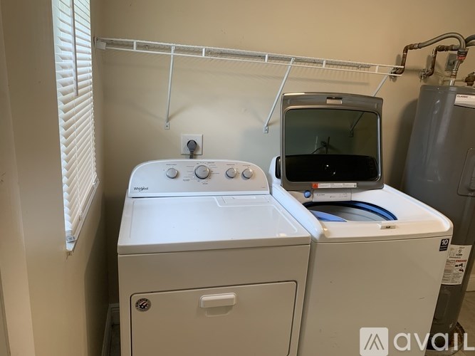 A washing machine and dryer are in a small room.
