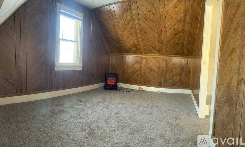 A room with wooden walls and a window.