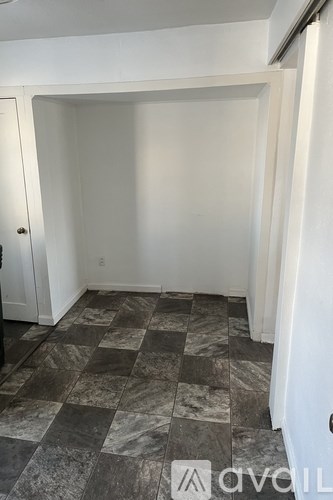 A room with a checkered floor and white walls.