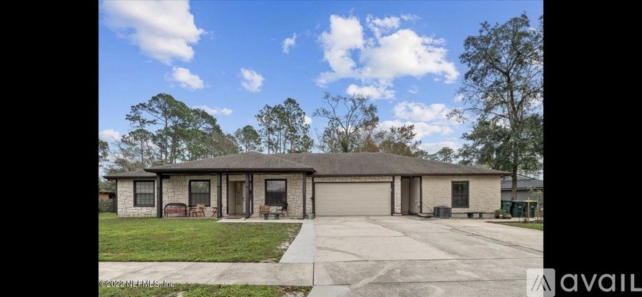 A house with a brown roof and a garage door is available for sale.