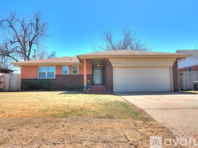 A house with a garage and a driveway in front.