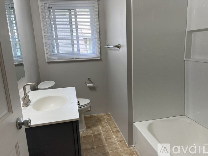 A bathroom with a sink, toilet, and bathtub.