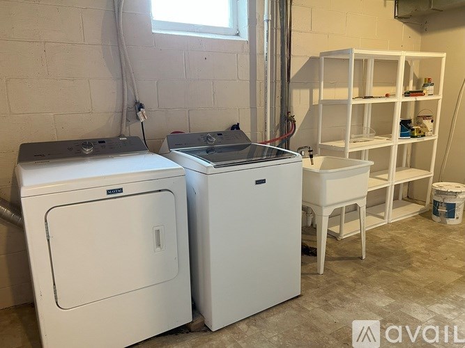 A white washing machine and dryer in a laundry room.