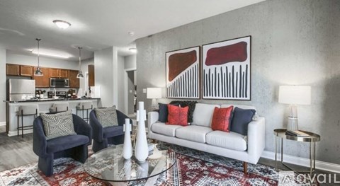 A living room with a white couch and a rug.