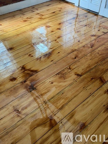 A wooden floor with a logo that reads "avail".