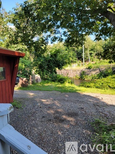 A gravel path leads through a lush green landscape.