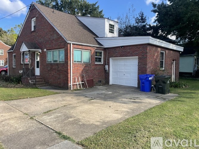 A red brick house with a white garage door.