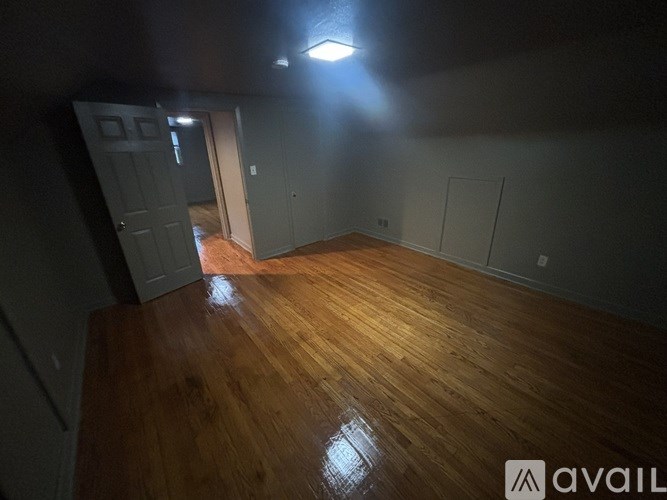 A room with wooden floors and a light on the ceiling.