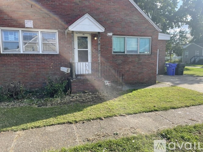 A small brick house with a white door and windows.