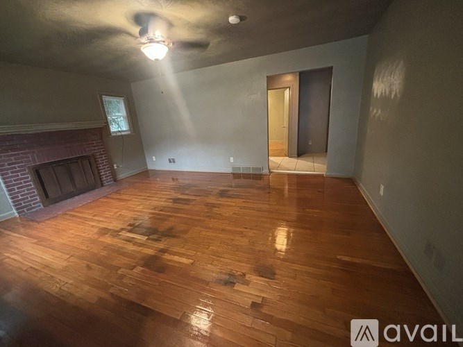 A room with wooden floors and a fireplace.