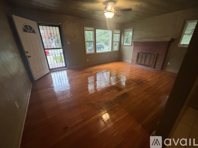 A room with wooden floors and a fireplace.
