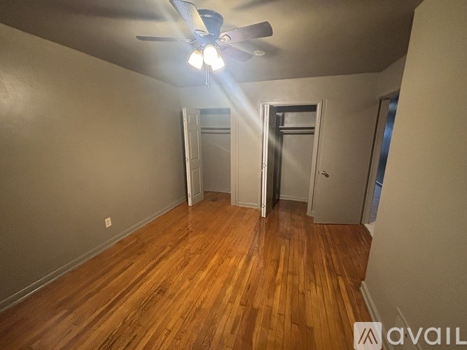 A room with wooden floors and a ceiling fan.