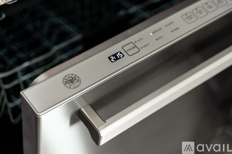 A close up of a stainless steel oven with a digital display showing the time as 2:15.
