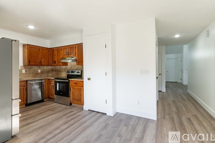 A kitchen with wooden cabinets and stainless steel appliances.