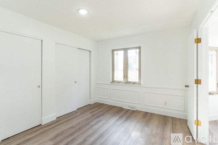 A room with white walls and a window with a white frame.
