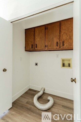 A room with wooden cabinets and a white door.