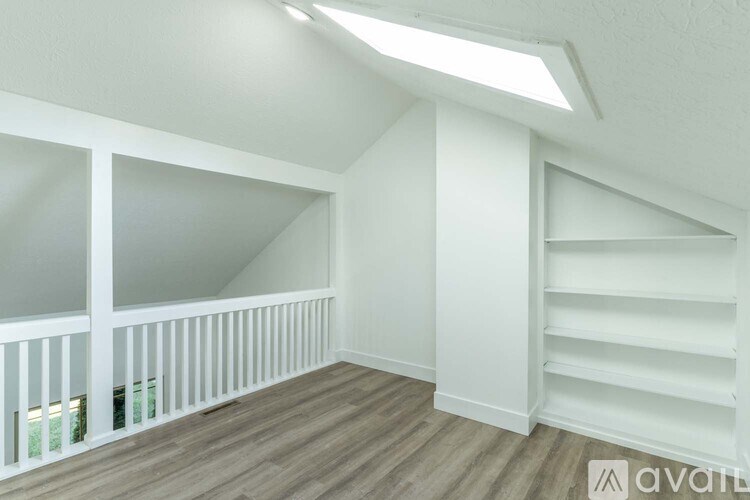 A room with a wooden floor and white walls.