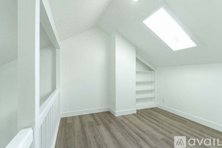 A room with a wooden floor and white walls.