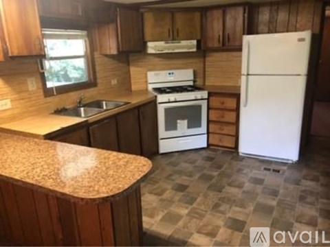 A kitchen with a white fridge and a white stove top oven.