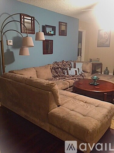 A living room with a couch and a table.