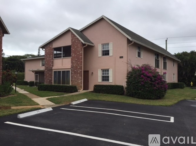 A building with a parking lot in front of it.