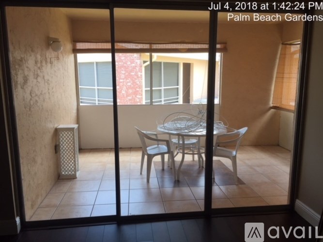 A patio with a table and chairs is visible through a sliding glass door.