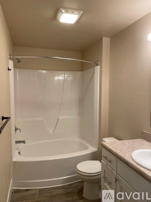 A bathroom with a toilet, sink, and bathtub.