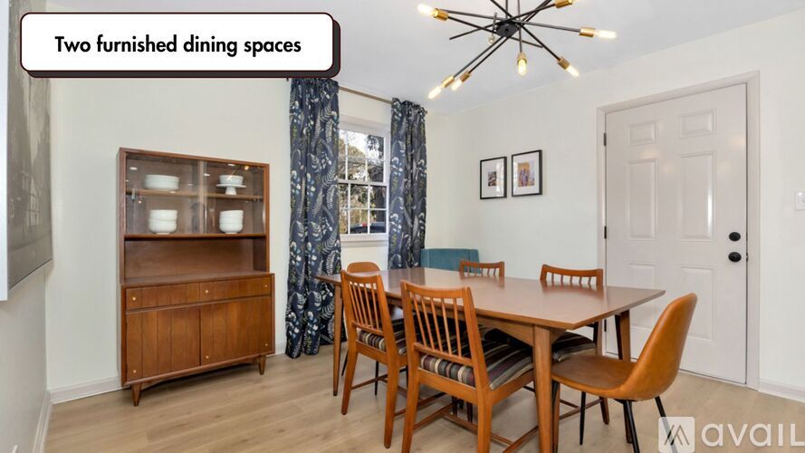 A dining room with a wooden table and chairs.