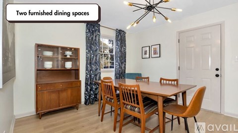 A dining room with a wooden table and chairs.