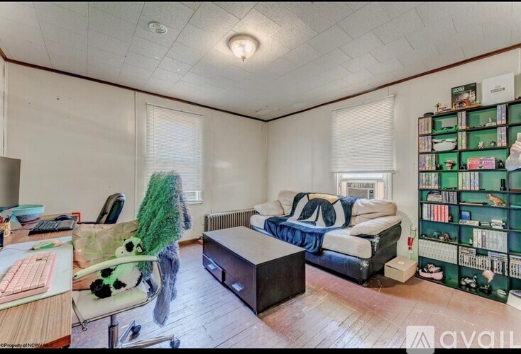 A room with a bed, a desk, and a bookshelf.