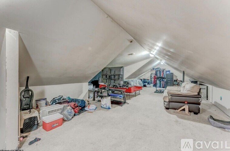 A storage room with various items and a fan.