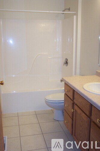 A bathroom with a toilet, sink and shower.
