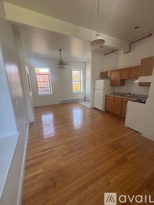 A room with wooden floors and white walls.