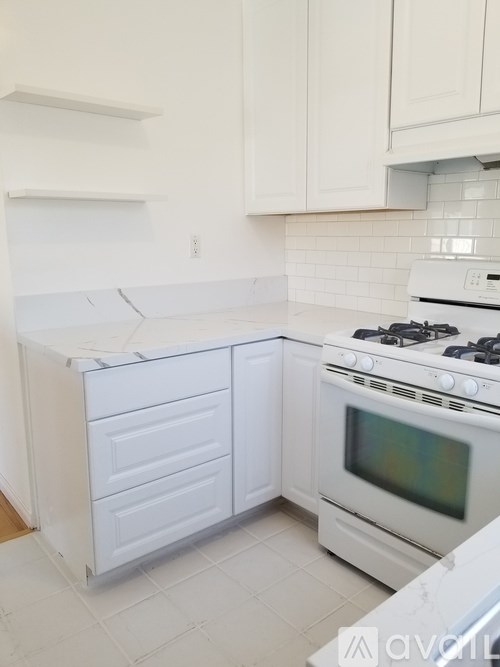A white kitchen with a stove and oven.