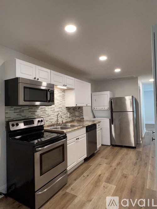 A kitchen with black and stainless steel appliances.