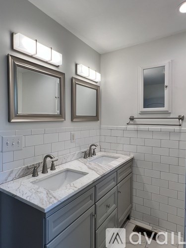 A bathroom with a sink and mirrors.