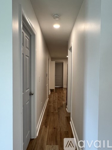 A long hallway with a door at the end.
