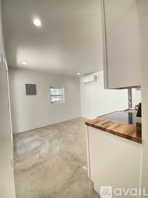 A room with a wooden counter and a window.