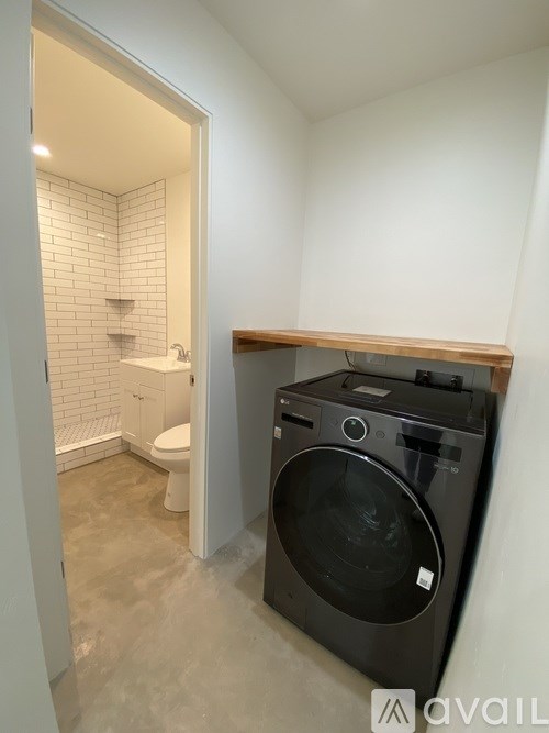 A small laundry room with a washer and dryer.