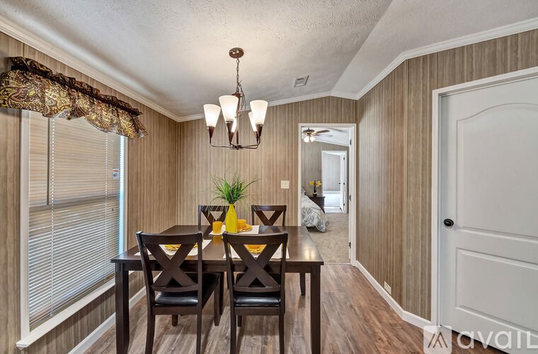 A dining room with a wooden table and chairs.