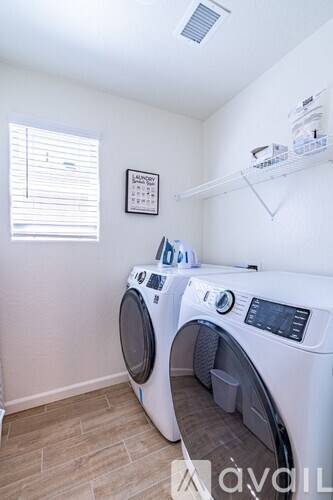 A small laundry room with a washer and dryer.