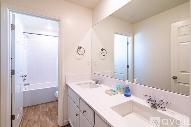 A bathroom with a white sink and a white bathtub.