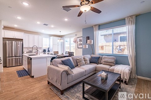A living room with a grey couch and a wooden coffee table.