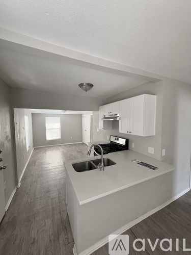 A kitchen with a sink and cabinets.