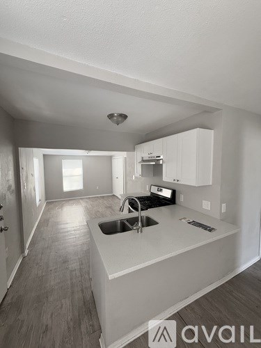 A kitchen with a sink and cabinets.